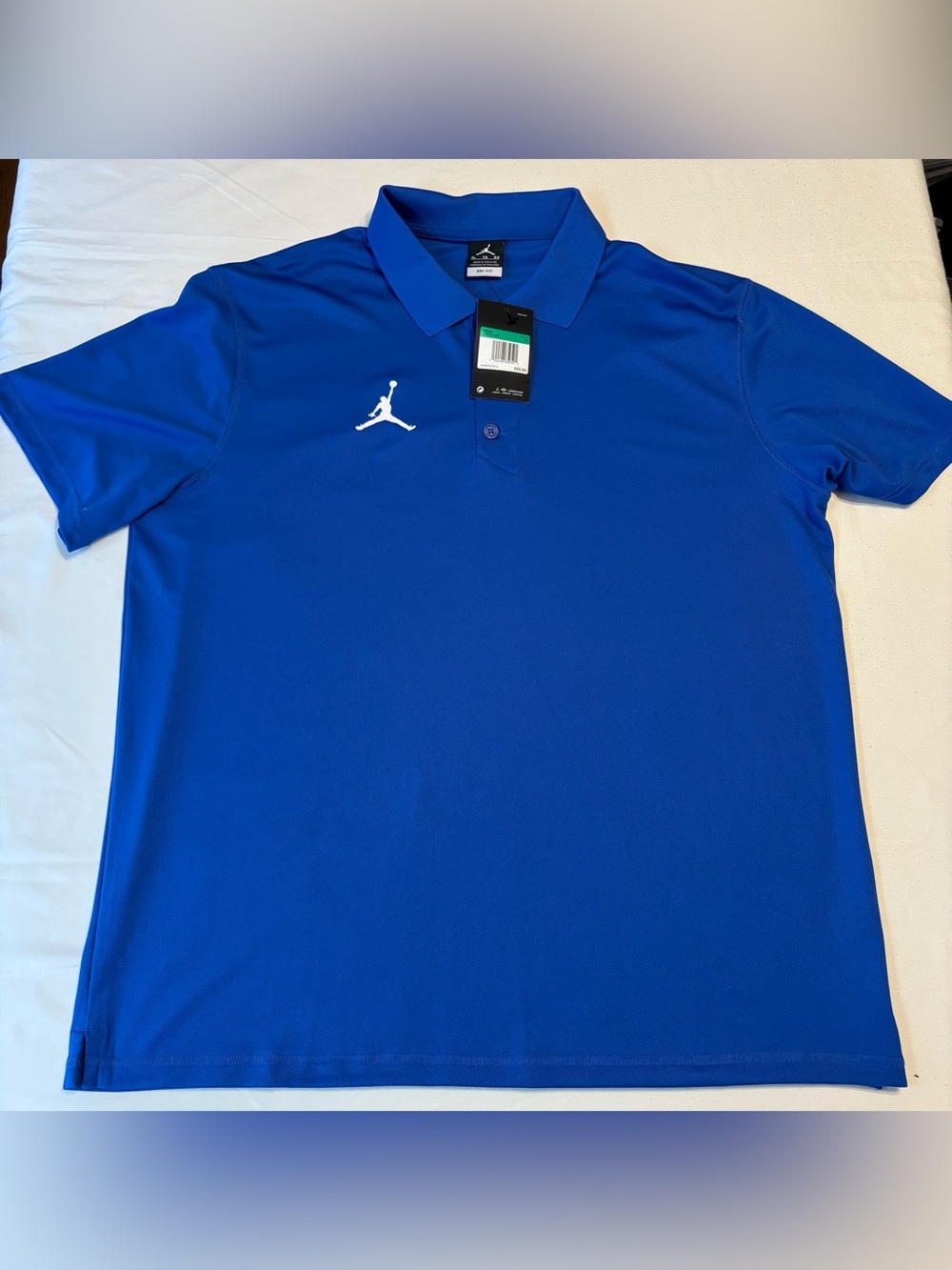 Blue Nike Air Jordan Dri-Fit Varsity Polo Shirt featuring a White Jumpman Logo
